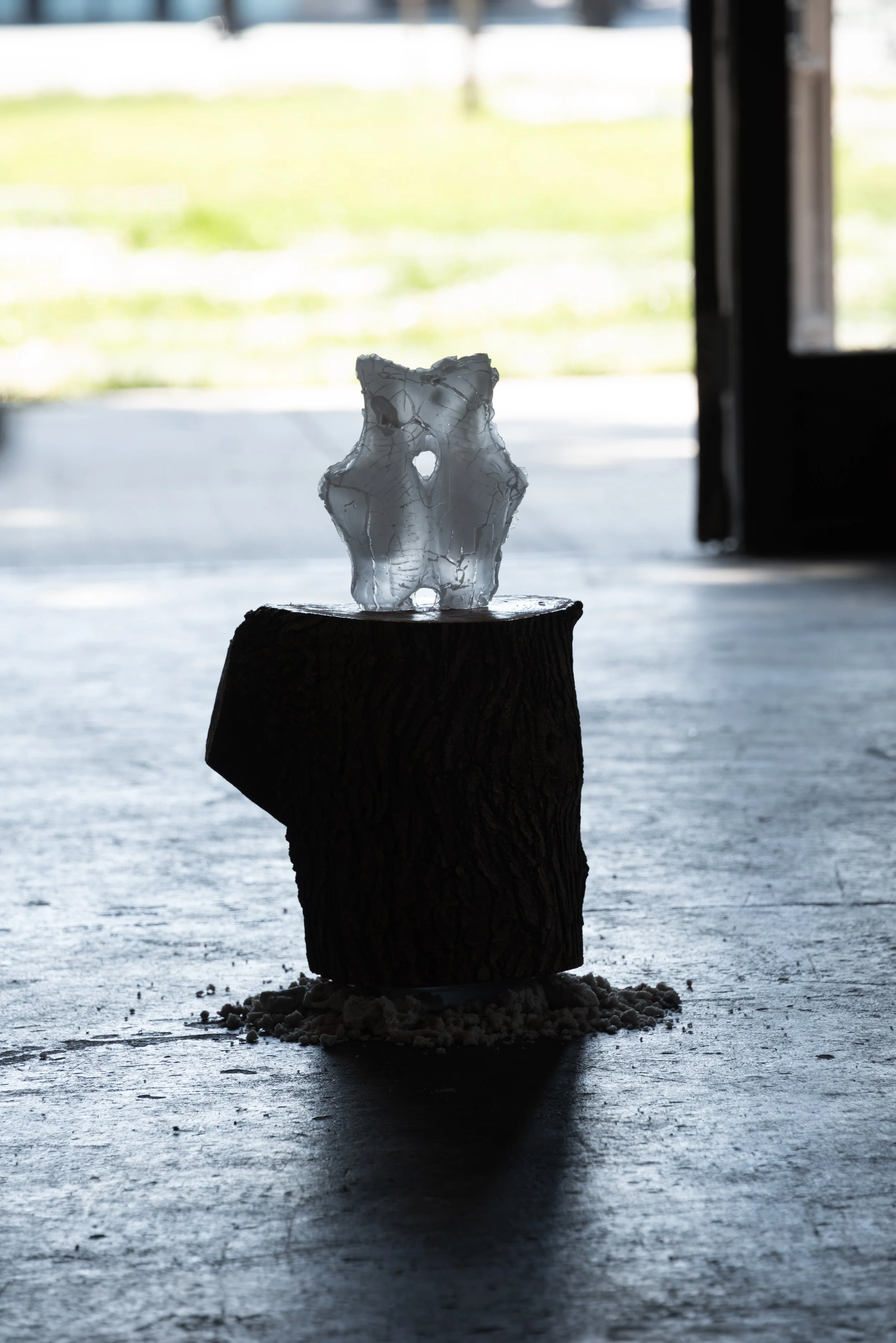  The Transformation, 2026,   cast glass, wood, cast stone,   15” x 15” x 22”  photo by Maria Burunderena 