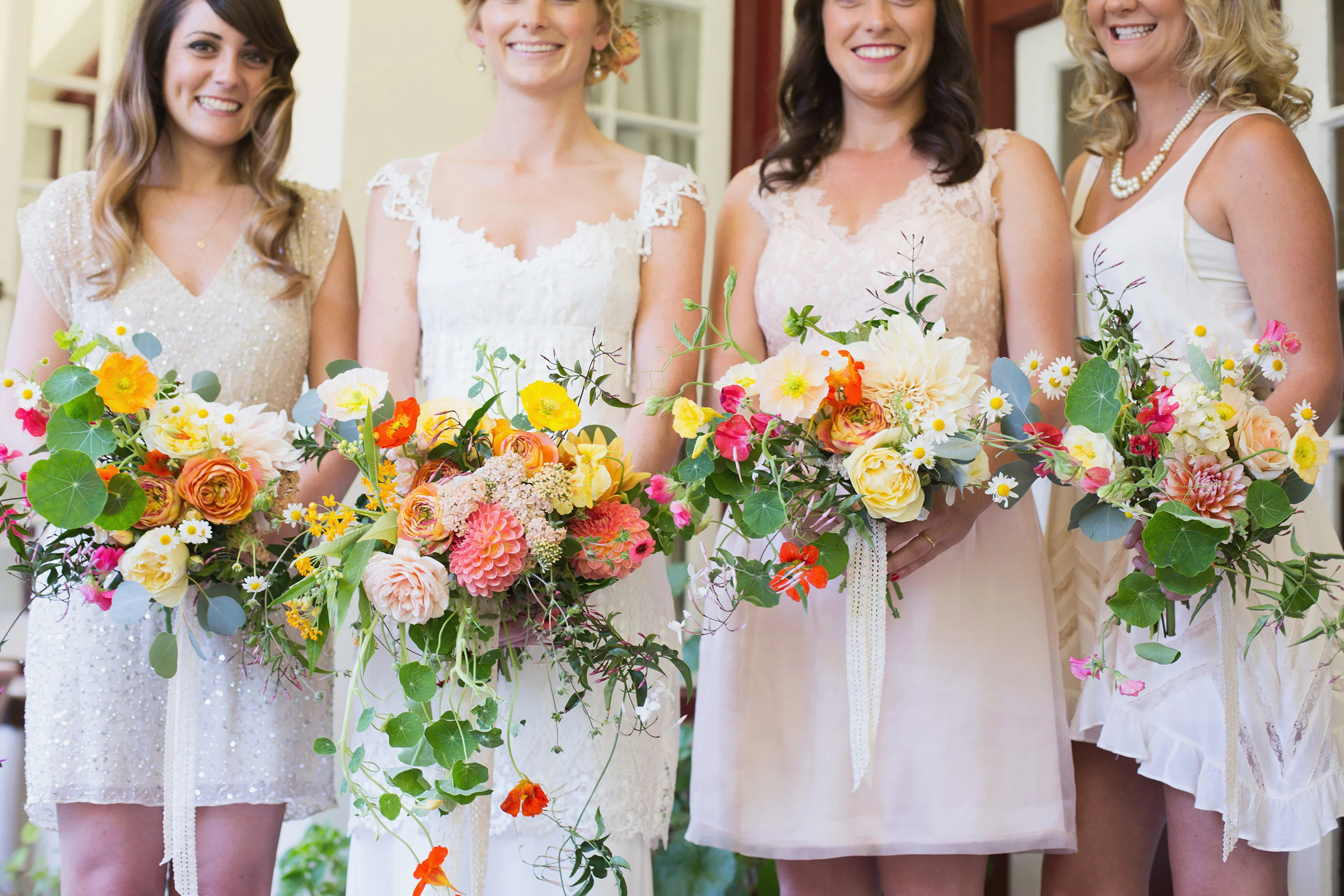 bride and bridesmaids smiling at Ralston White Retreat in Mill Valley