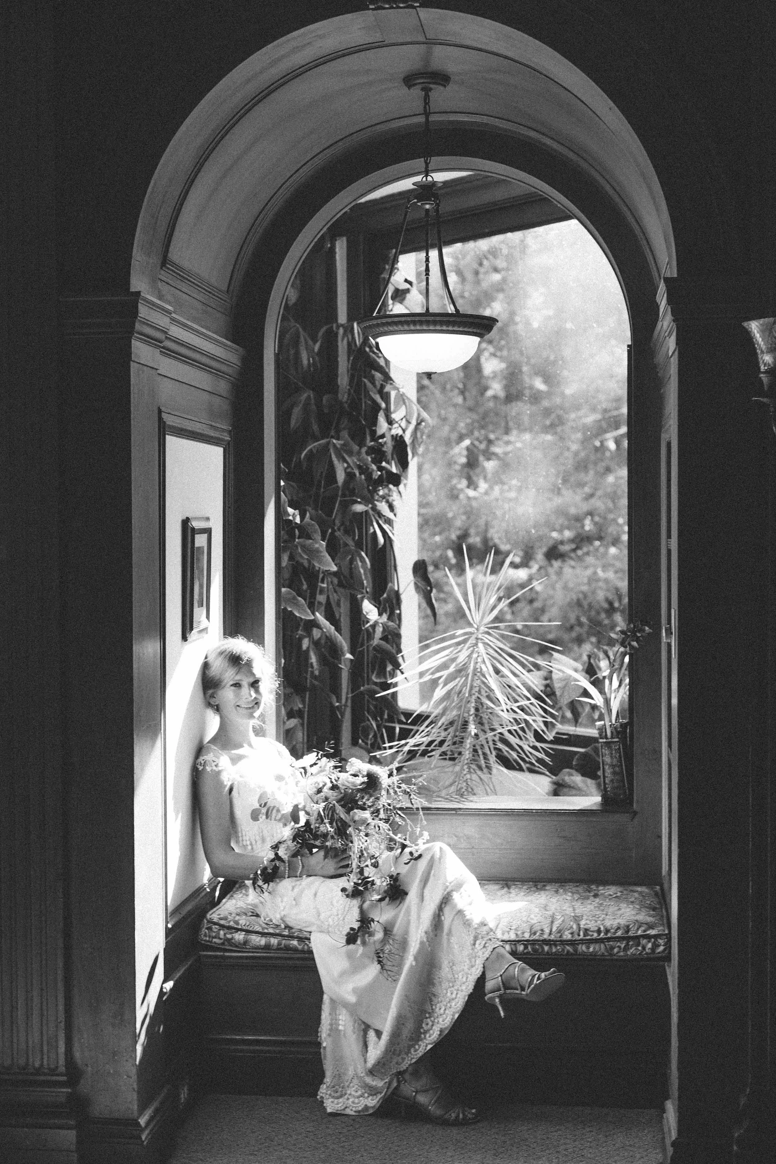 bride in arched window at Ralston White Retreat in Mill Valley