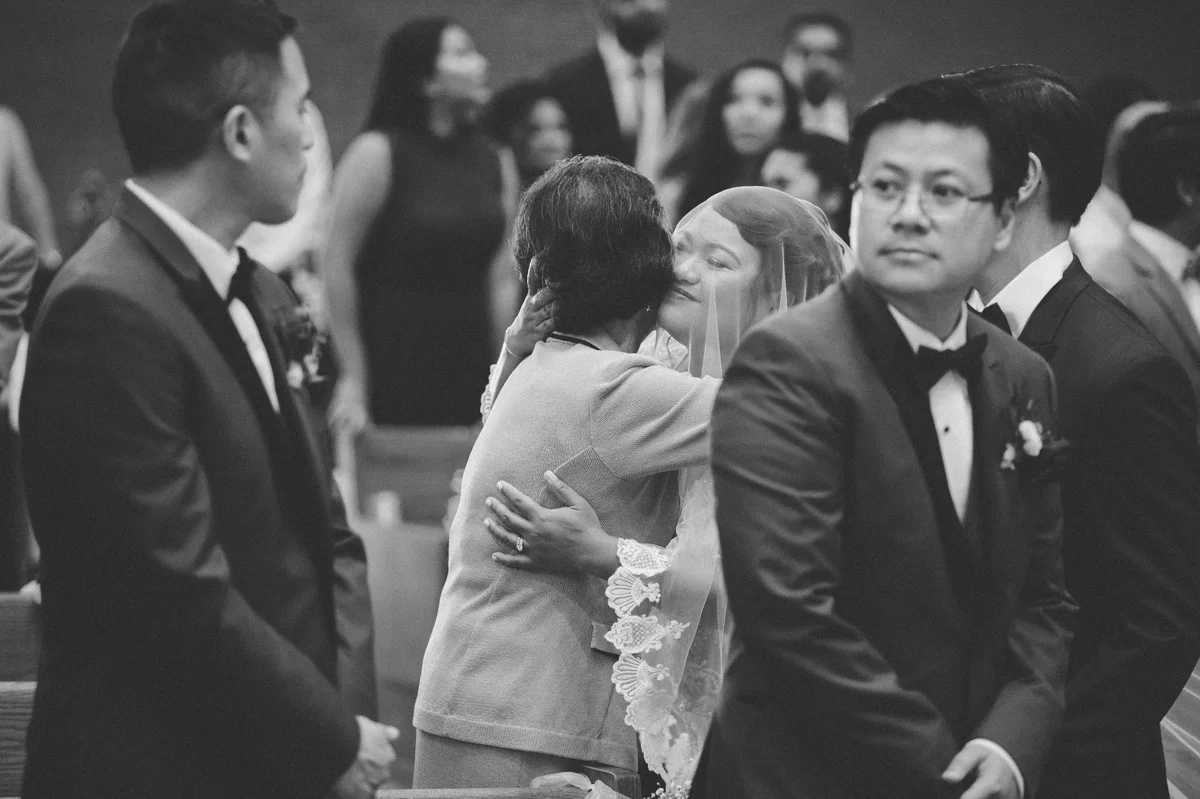 The bride embraces her mother-in-law during the Catholic ceremony.