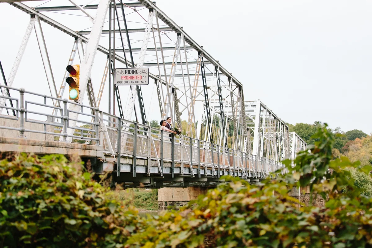 The bride and groom on the bridge at Washington Crossing Park.
