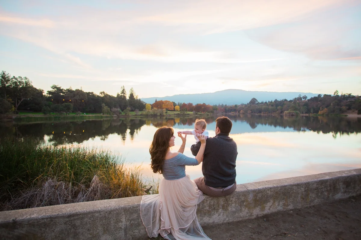 Sunset over Vasona Lake in Los Gatos, while a young family sits on the dam.