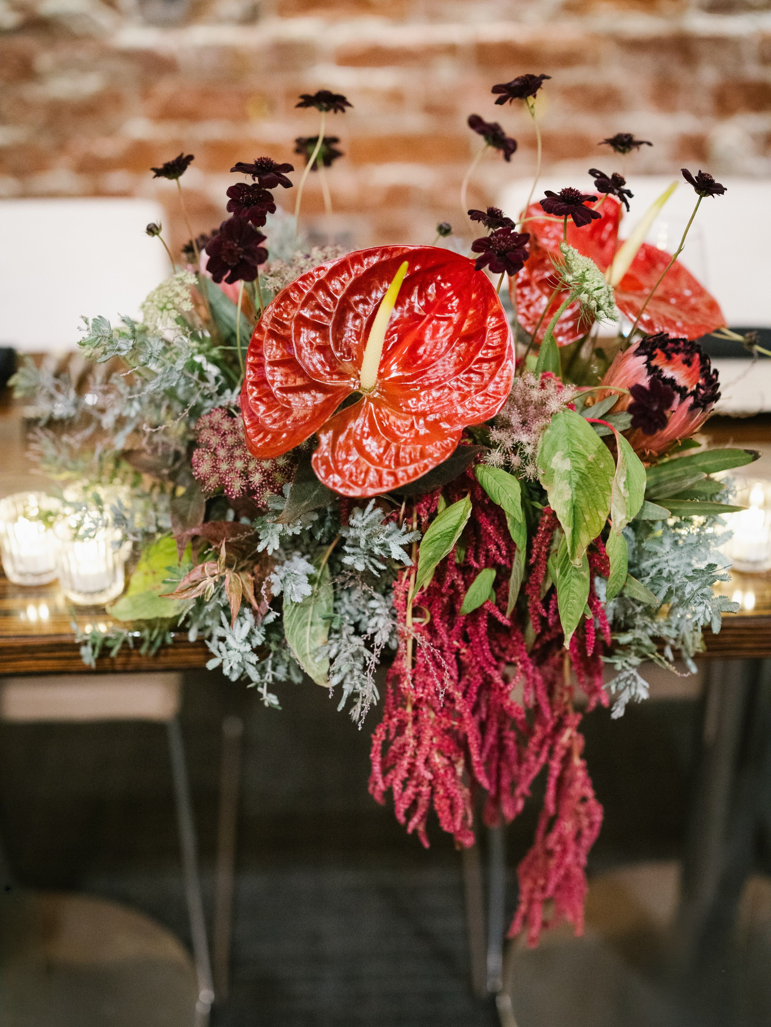 Gallery coming soon, but first: these florals 🤌

Red anthurium, chocolate cosmos, and hanging amaranthus made fall in the Bay Area look so good.

.
.
.
.
.
.
Venue &amp; Catering:  @25lusk 
Florals &amp; Planning:  @lovetheseflowerssf