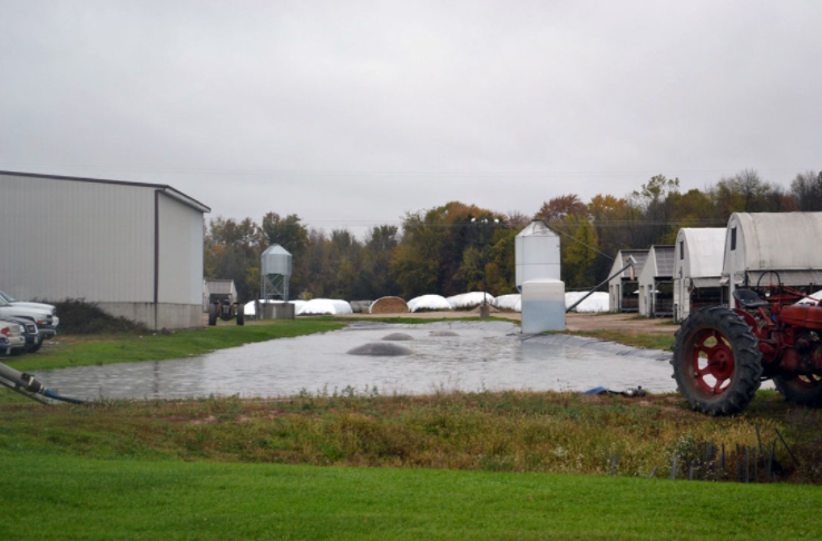 Kewaunee County citizens documented runoff from wastewater lagoon flowing through a parking ares and directly into a ditch leading to the East Twin River.