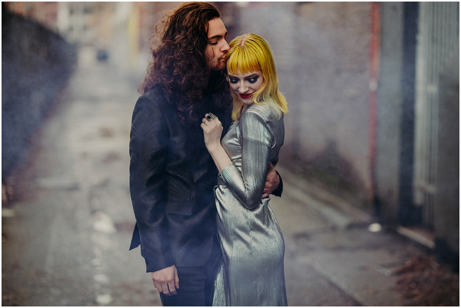  Vancouver love beautiful engagement couples session photography Urban steam Yellow hair blunt bangs centre part fingernails manicure curly long hair man glamour makeup red lips lipstick metallic dress retro modern black suit jacket 