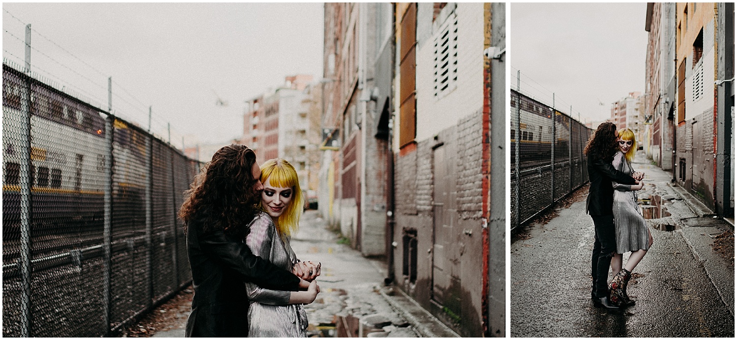  Vancouver back alley grunge session blood alley gas town tender love embrace chain link fence train couple engagement session 