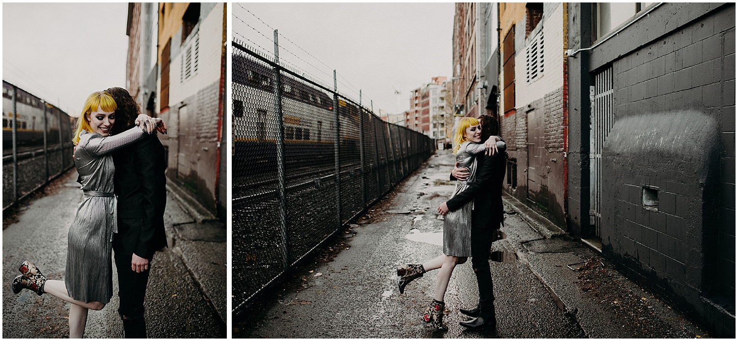  Vancouver back alley couples engagement session chain link fence yellow hair metallic dress love hug train yard 