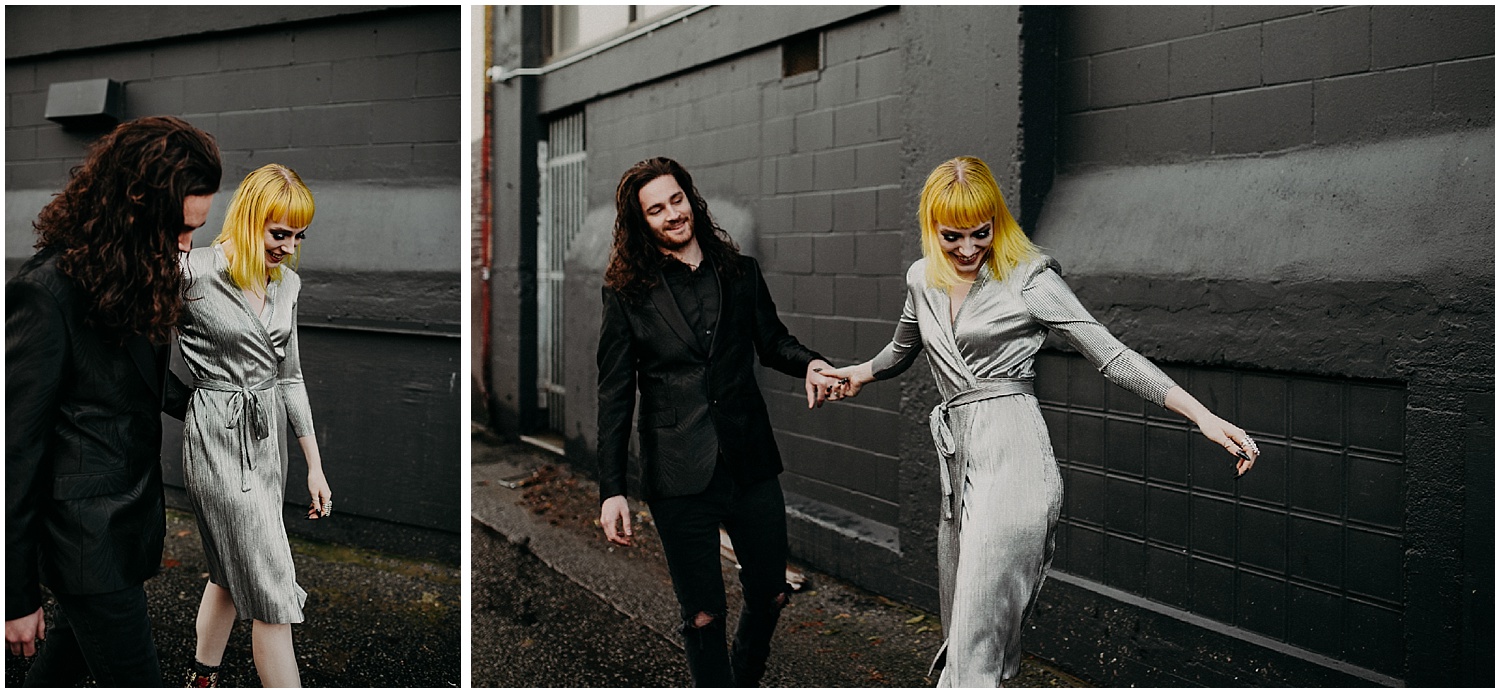  Vancouver back alley gas town blood alley metallic silver dress black suit laughing smiling couples engagement session shoot walking photography yellow blunt hair curly long hair man black brick concrete jungle industrial style 