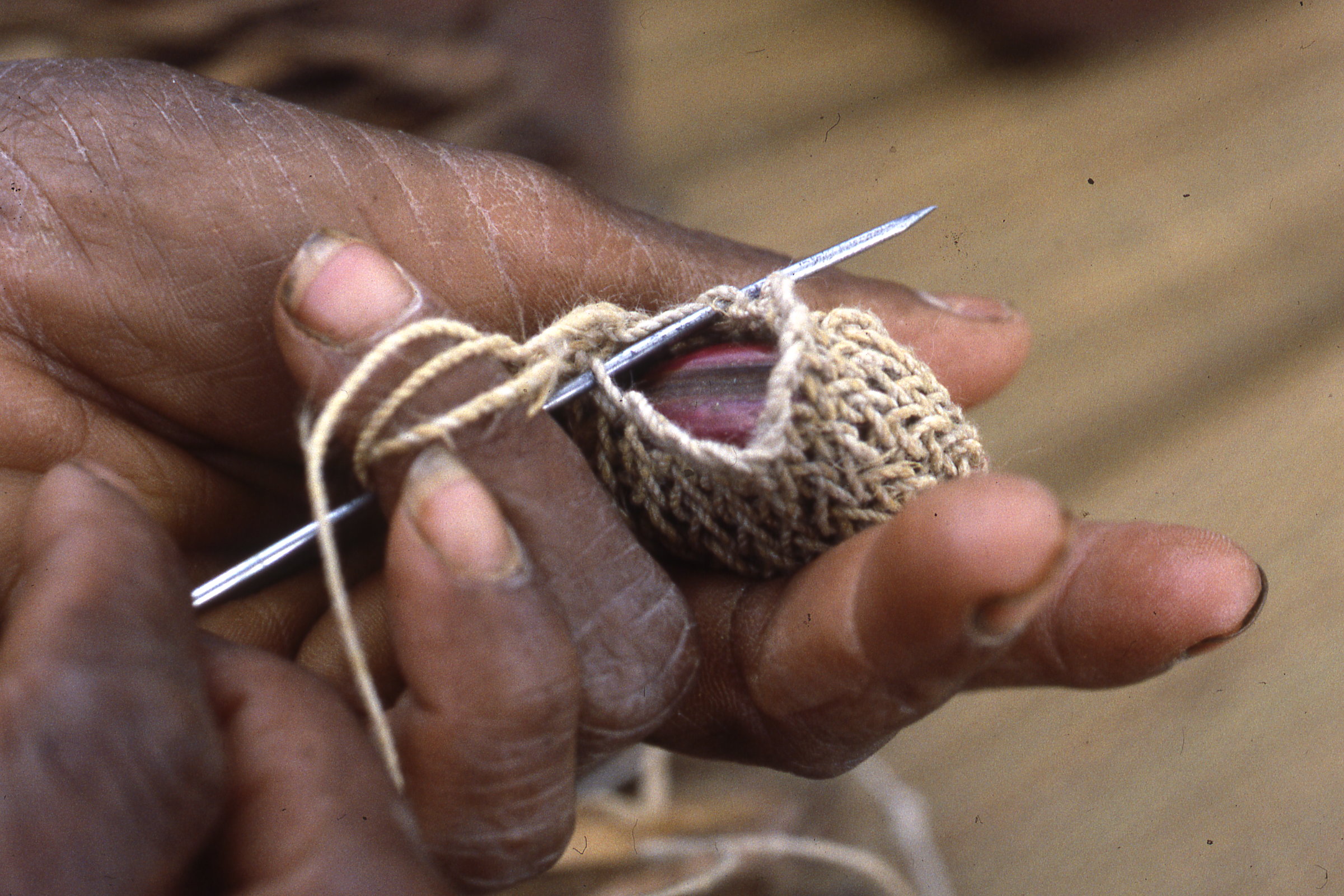 Oksapmin woman making amulet bag, early 1980s (Photo M. MacKenzie).