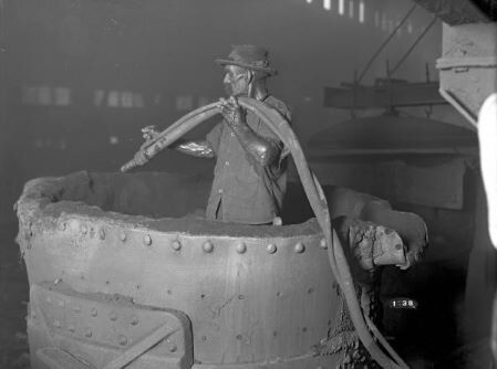 Man holding hose at the Buckeye Steel Castings company.