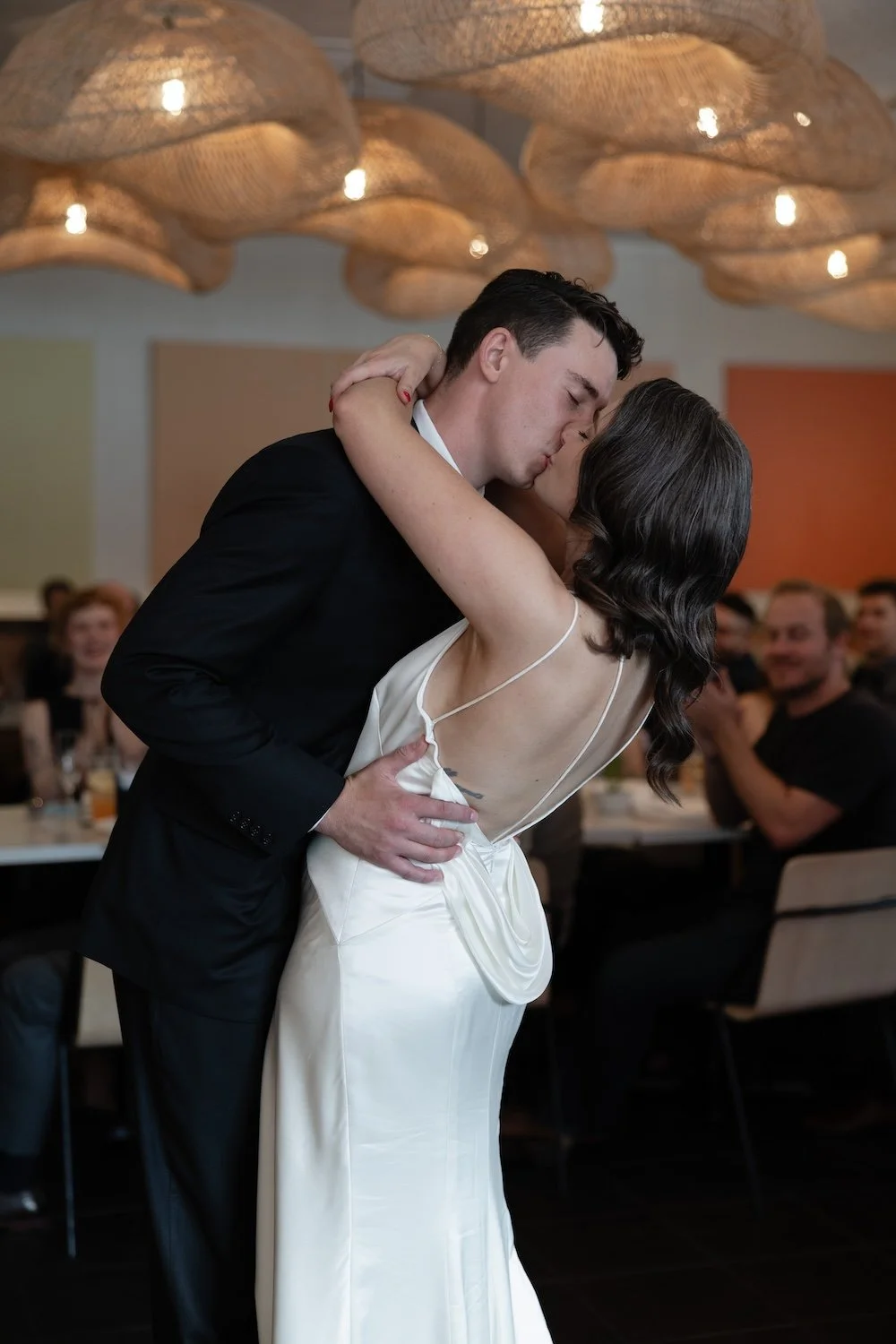 Newlywed Couple Kissing at their wedding reception