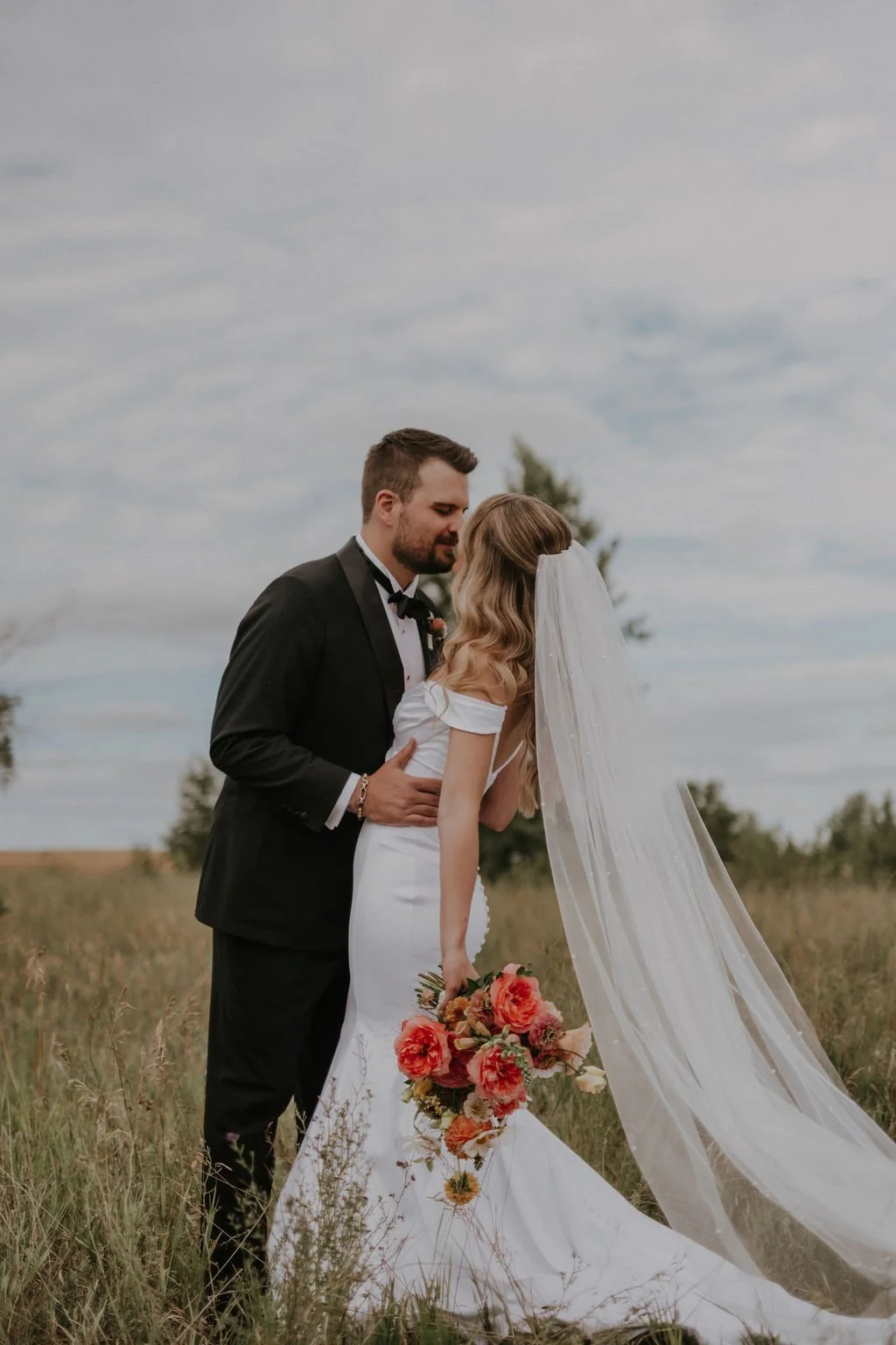 Newlywed Couple kissing for Photos on the Prairies in Manitoba