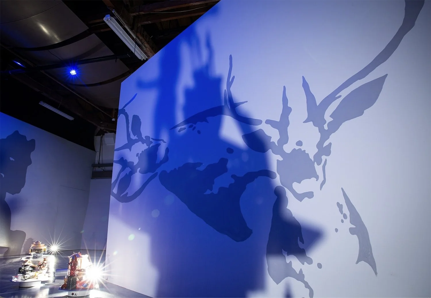    Polyglots (Atmoshperes of Influence)  , 2023, installation, murals, Taiwanese souvenirs, rotating motors, shadows, Sia-long, Jaili, Taiwan, dimensions variable 