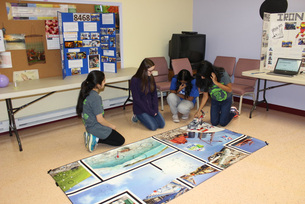  Krittika and Susan help the girls run their program on the Lego robot.&nbsp;Girl Scout Lock-in Outreach, February 2017. 