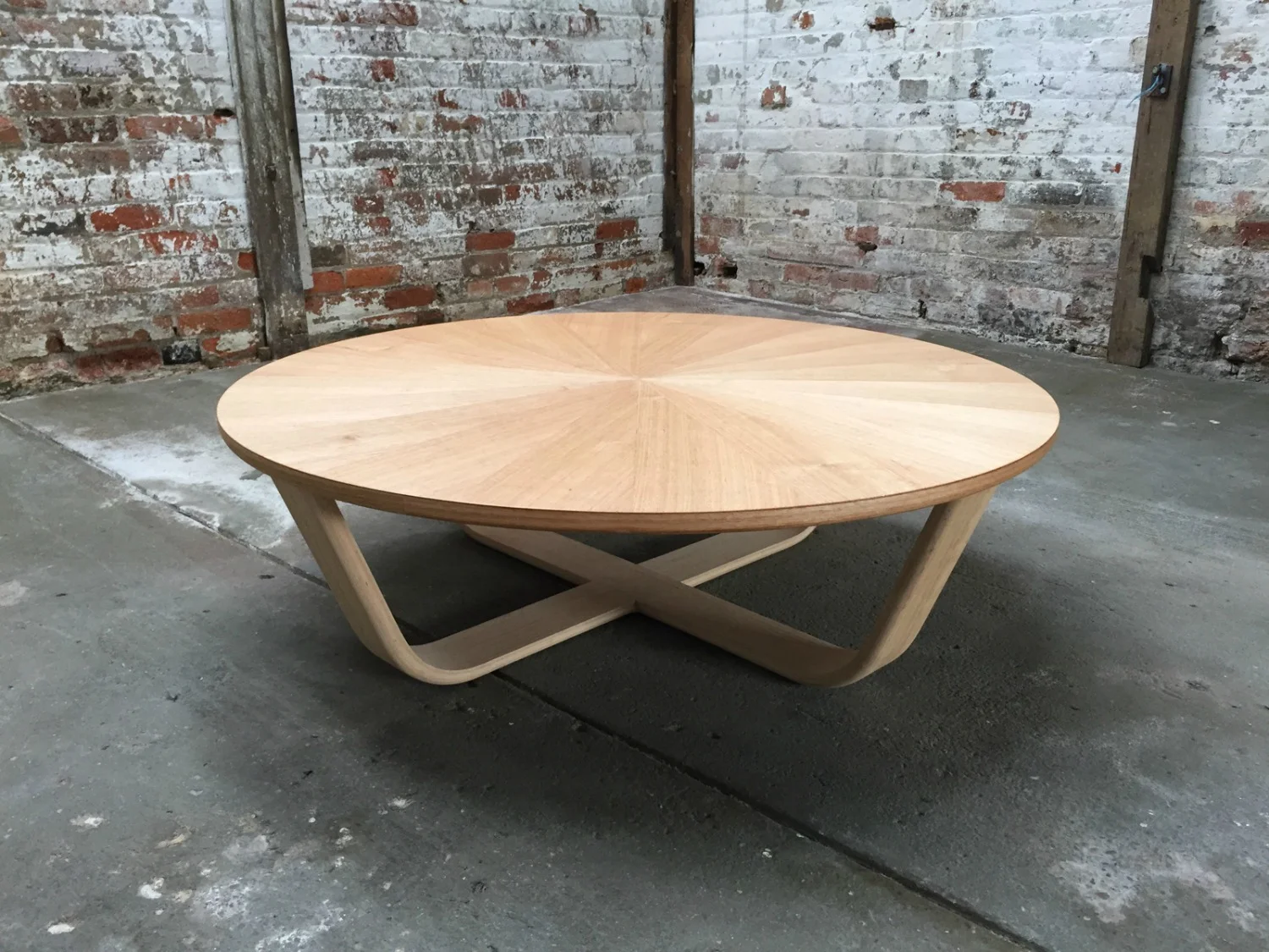 This striking handcrafted coffee table was designed by Simon Ancher Studio , in Launceston TAS. A sunburst pattern is created by arranging veneer sheets around a centre point. The tapered shape of each segment draws the eye to the centre of the table.
