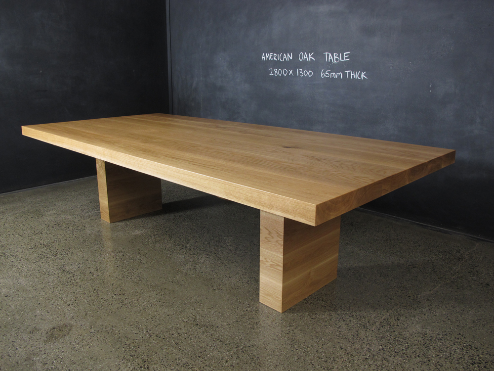 This solid dining table was handmade and designed by Chrisian Cole Furniture , Brunswick VIC. The Amercian Oak is 60mm thick and the base's practical design enables lots of people to sit around it.
