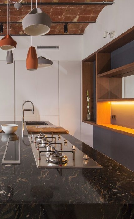 the amazing vaulted ceiling is ceramic with iron beams and the benchtop is Stromboli granite Apartment in Barcelona, Spain | by Nook Architects | Photography by Nieve