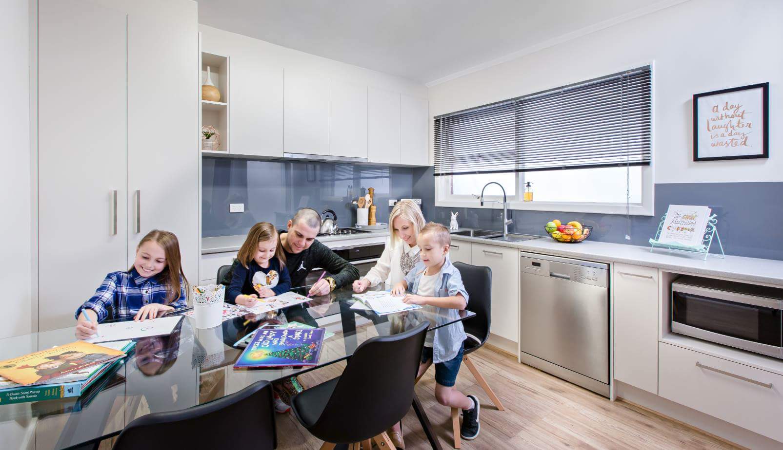 Emma and her family, enjoying the new kitchen | source