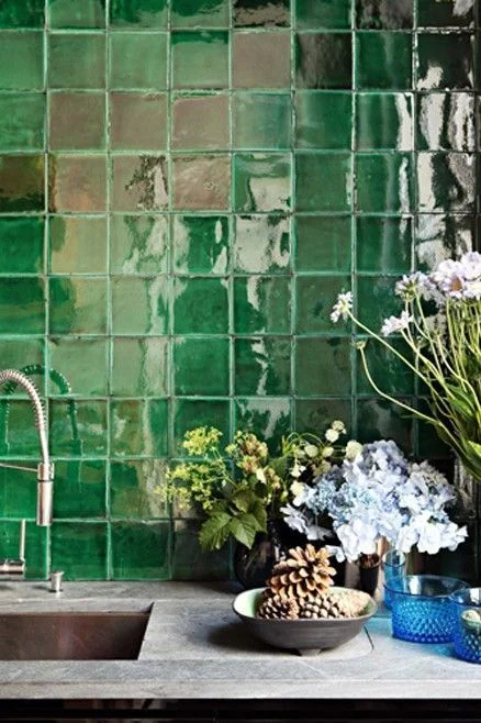 Dramatic green Zellige tiles feature in this Parisian kitchen. Interior Design: Studio Ko