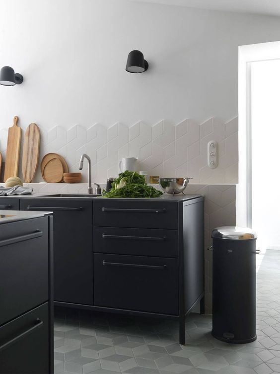 I love the edge detail on this splashback, using unfinished 3D cube shaped tiles. French farmhouse kitchen with black steel cabinets from Vipp