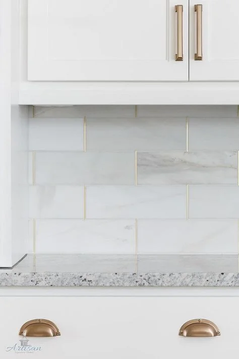 Lovely use of gold in the vertical grout lines of these brick tiles are. It also ties in with the handles. Designed by Gretchen Black for Artisan Signature Homes