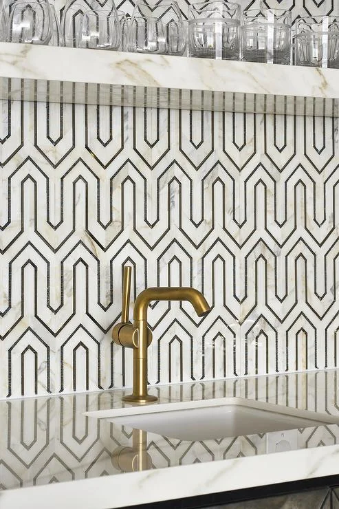 Geometric marble and metallic splashback. Photography: Stephani Buchman