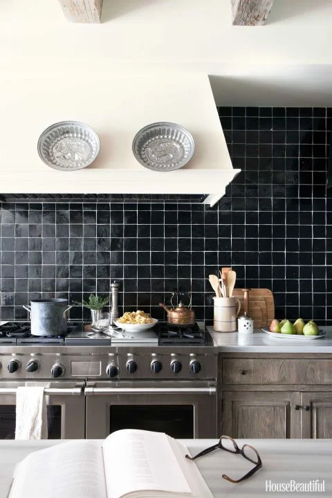 Timeless Los Angeles kitchen with black Zellige tiles and white grout for a graphic look. Interior Design: Chris Barrett