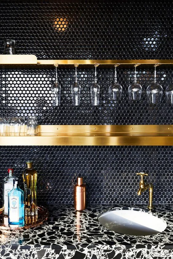 Black gloss penny round tiles for a glamorous evening drinking cocktails. Designed by: GRT Architects
