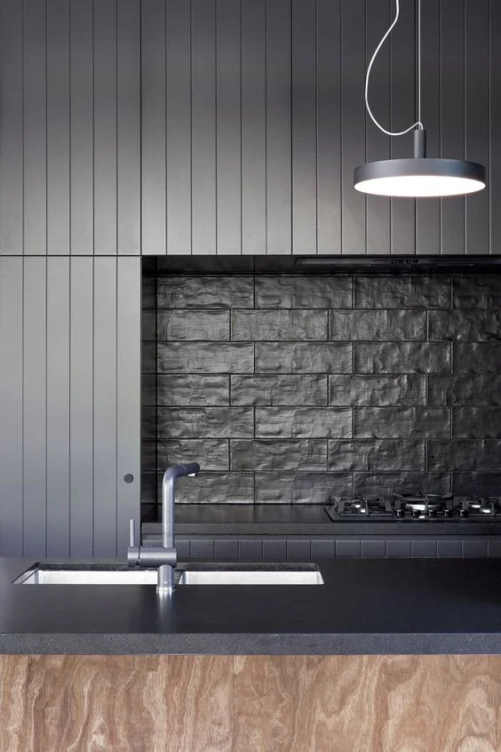 An all black colour scheme really benefits from texture in the tiles. Architects: Splinter Society