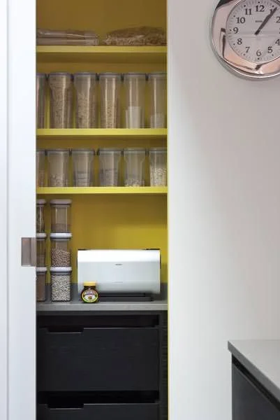 A pop of zesty lemon yellow in this modern pantry. Mowlem & Co