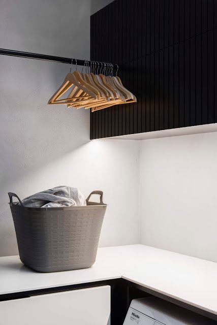 Stylish black hanging rail and great lighting in this modern laundry. | Minosa Design