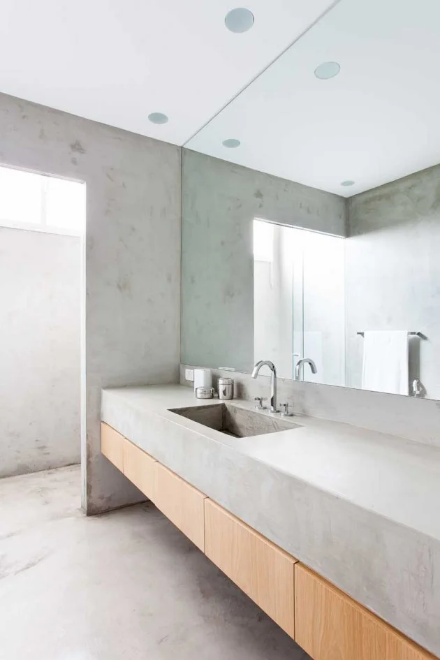 Slim-line oak vanity cabinet with concrete slab benchtop. In fact the rest of the bathroom is all concrete. | designed by Felipe Hess for a young actor that lives in Sao Paulo, Brazil