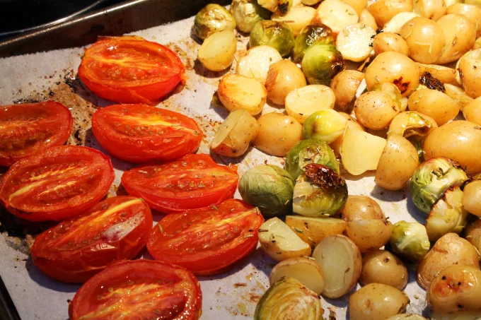 Tomatoes for the sauce roasting alongside the sprouts and potatoes