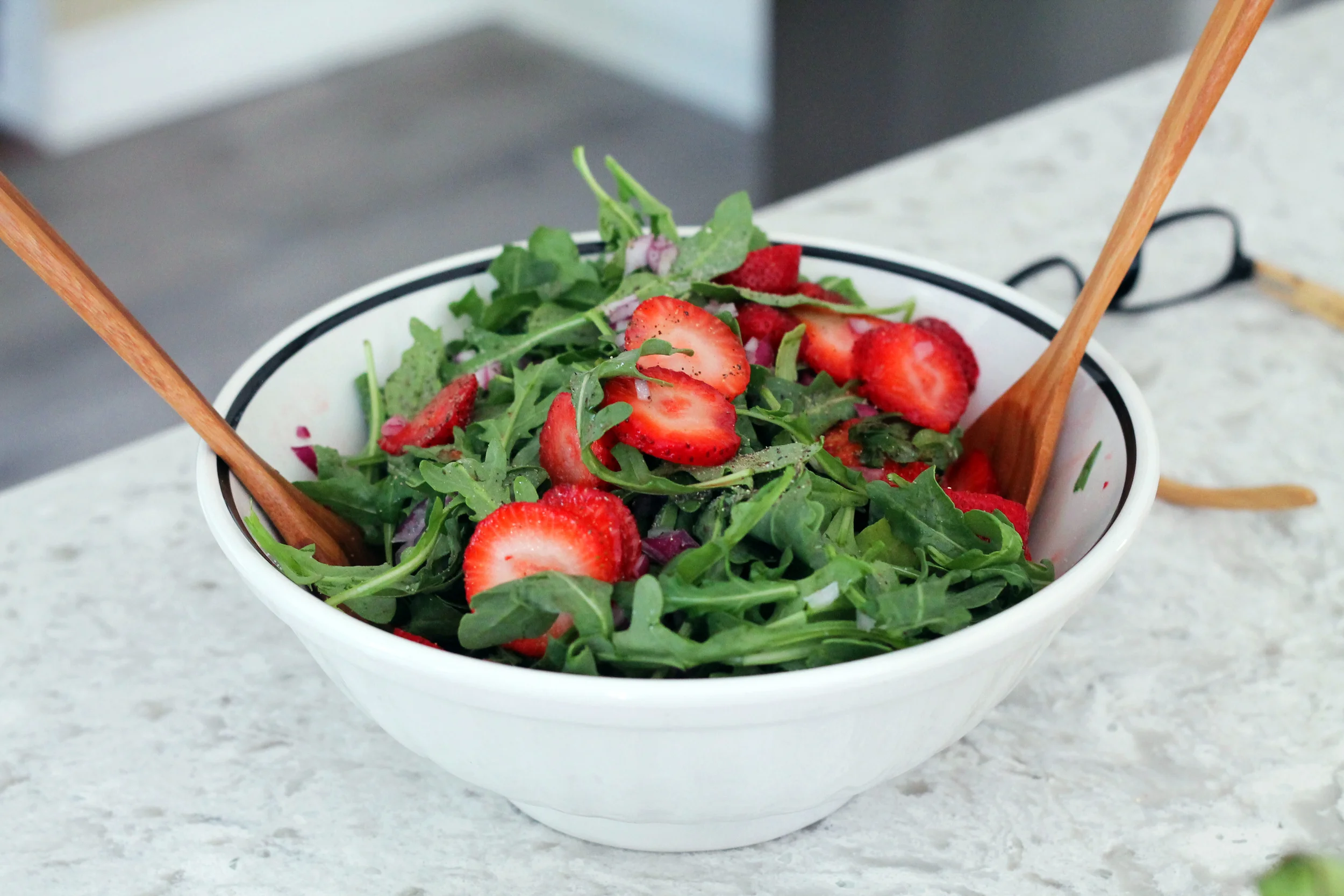 My mom whips up a fresh arugula and strawberry salad.