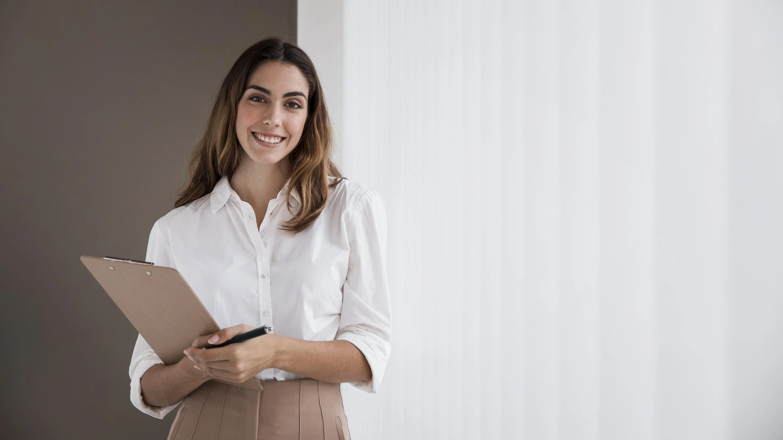 front-view-elegant-businesswoman-holding-clipboard-with-copy-space.jpeg