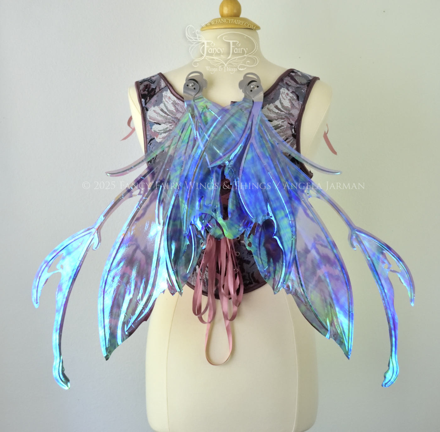  Purple &amp; blue iridescent fairy wings with a spikey profile and antennae, with silver veins, are viewed from the back in resting position, worn on a dress form 