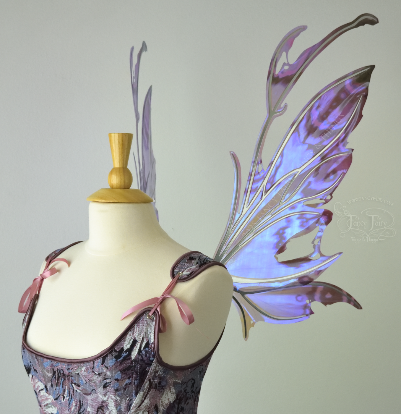  Purple &amp; blue iridescent fairy wings with a spikey profile and antennae, with silver veins, are viewed from the right side, worn on a dress form 