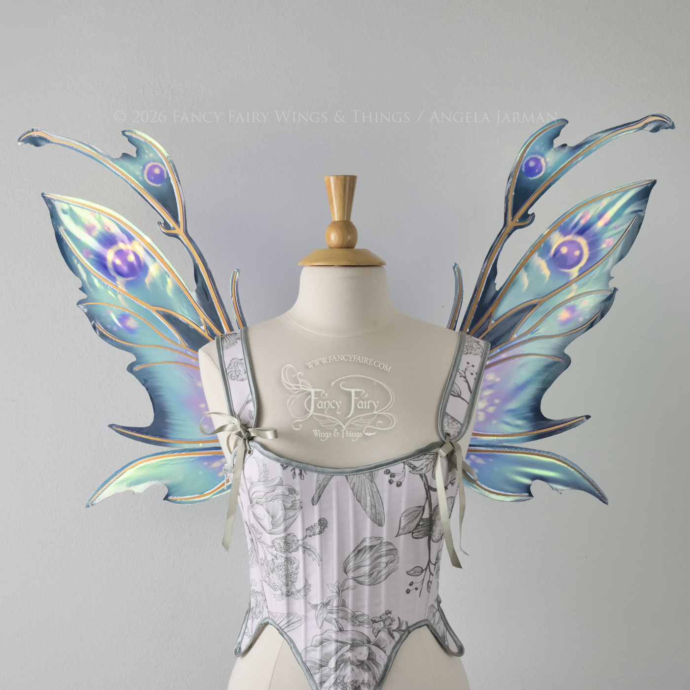  Iridescent fairy wings with a spikey profile &amp; antennae worn on a dress form, painted in shades of teal and purple, front view 