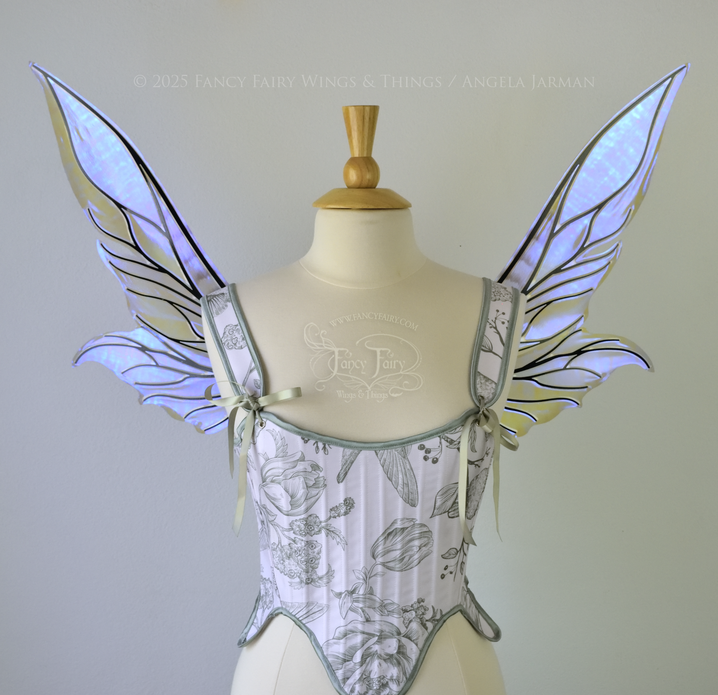 Iridescent & transparent violet fairy wings with elongated pointy upper panels and small leaf like lower panels, with black veins, right side view