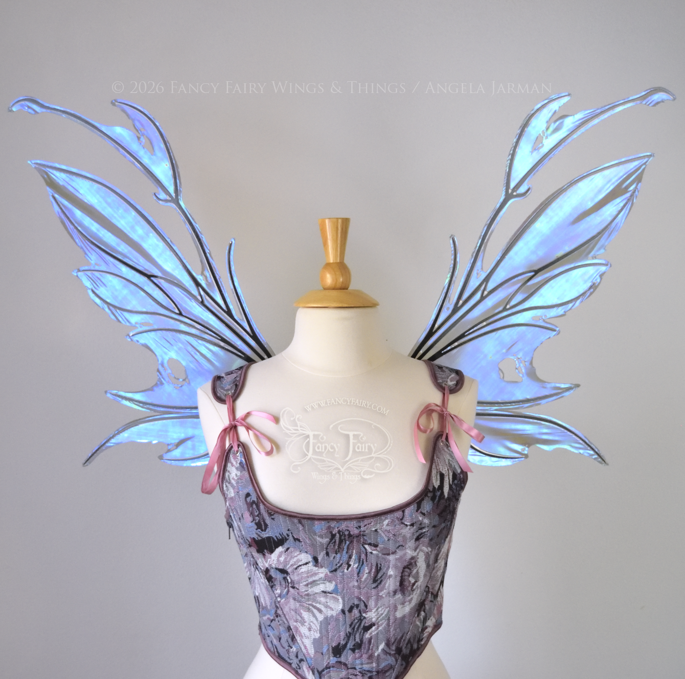 Iridescent & transparent purple & blue fairy wings with black veins and antennae, worn on a dress form, front view