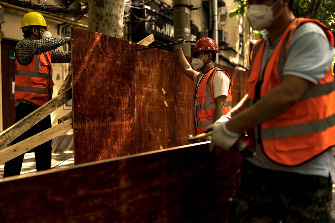  Workers removing fences used to contain people during the lockdown in Shanghai, China as the lockdown is lifted on June 1st, 2022. 