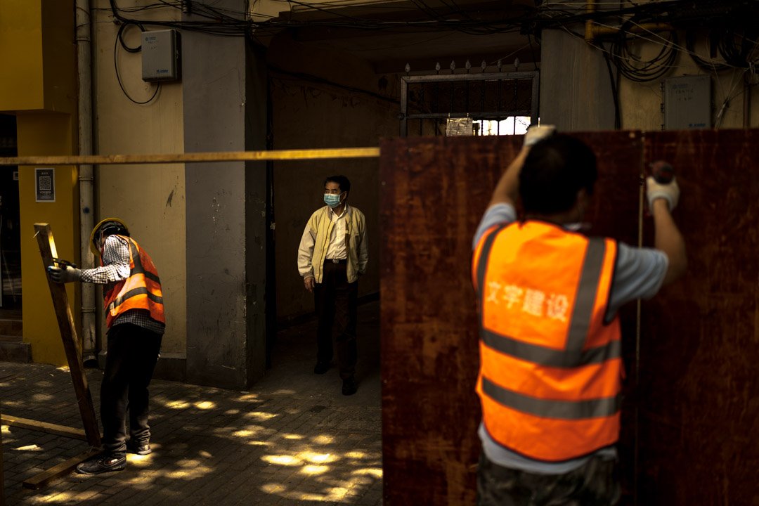  A resident of a lockdown building reacts as workers removing fences used to contain people during the lockdown in Shanghai, China as the lockdown is lifted on June 1st, 2022. 