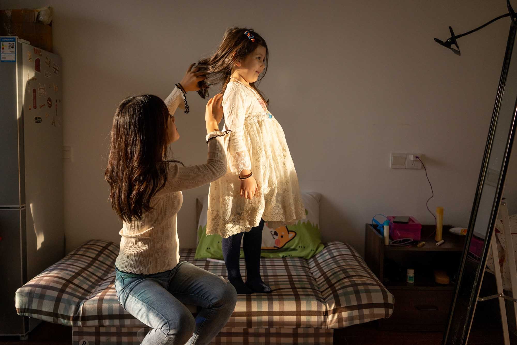  Hana and her daughter in their apartment in Yiwu, China. 