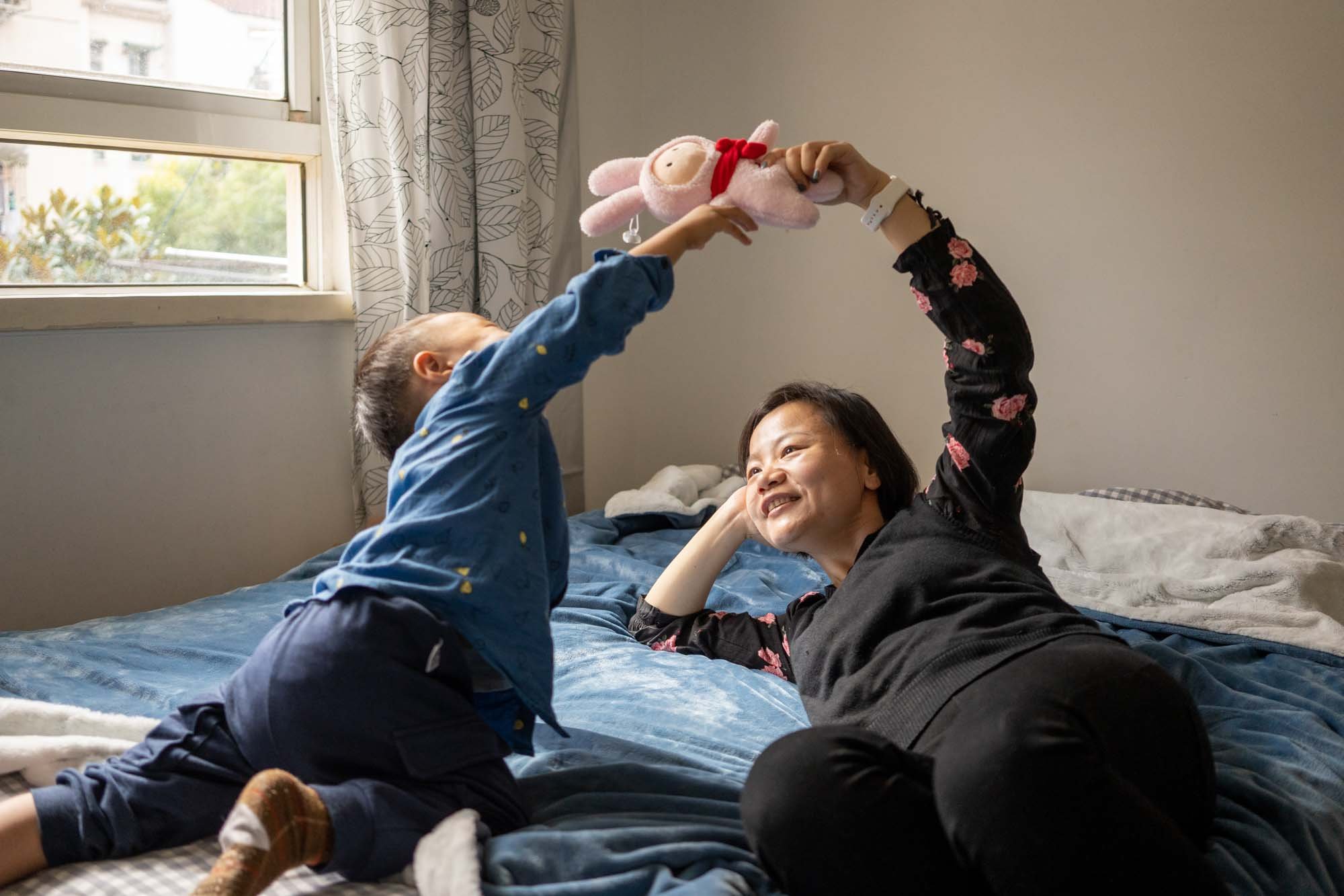  Yan and her son Yu in their apartment in Shanghai, China.She has been raise her son alone for the past 3 year after the divorce 