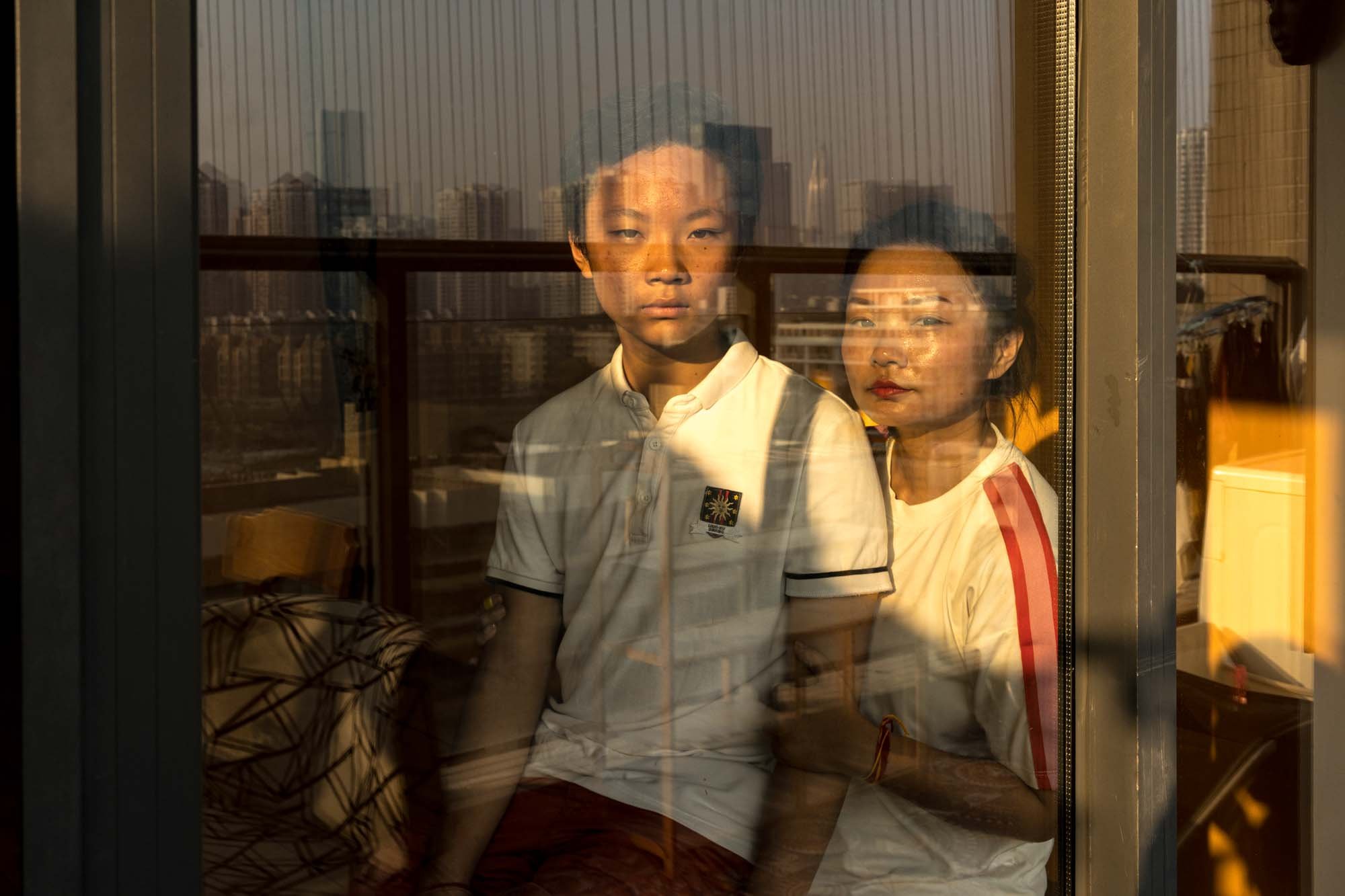  Liuchang and her son GuiBangLuoin their apartment in Shenzhen, China.Liuchang has been divorced and raise her son by herself for five years. 