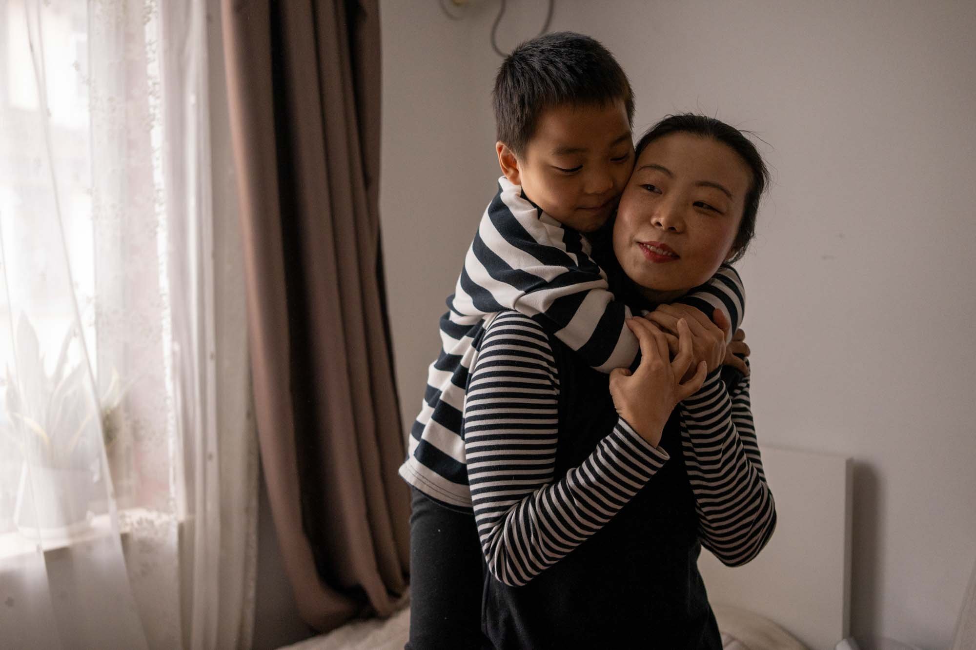  Yue and his son at her home in Shanghai, China 