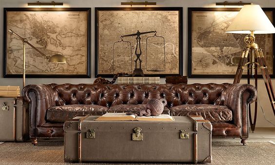 The maps in this room really help to add impact to this gentleman's club look. Using three different maps, but in similar tones mean they stand out, but do not overpower. The quirky furniture, objects and floor light look great against the antique map background.