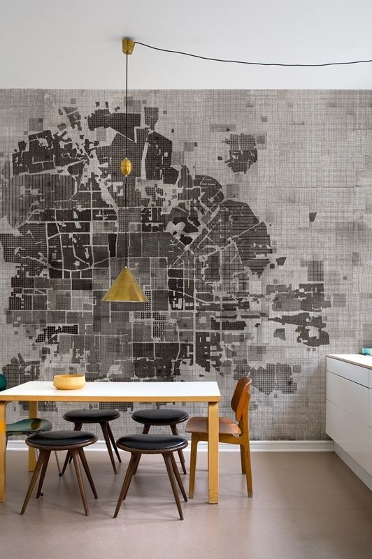 A lovely room. The gold lampshade pops against the black and white map and draws your eye to its centre before you take in all of the map and then the rest of the room. The black stools and light table help to actor the map in the room, so everything is brought together.