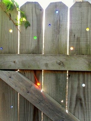Put marbles into your garden fence for some lovely colour as the sun rises and sets.