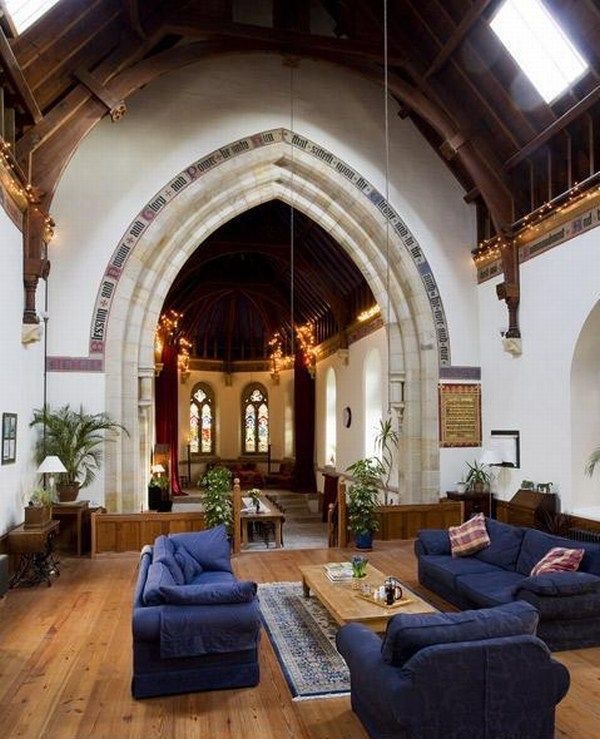 The height and shape of this ceiling draws your eye upwards. However, the wooden floors and furniture help to anchor the living space.